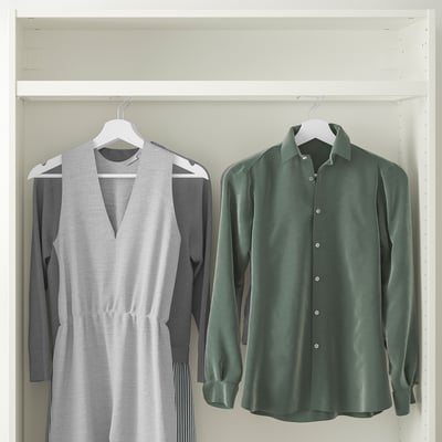 Two garments in wardrobe: grey dress, green shirt.