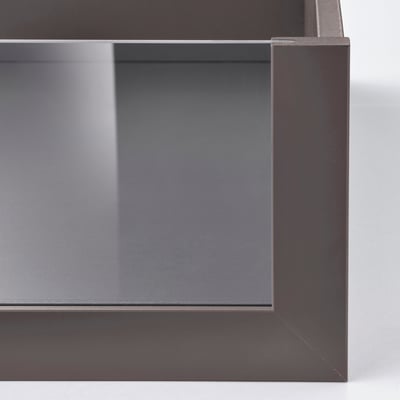An empty, modern drawer named KOMPLEMENT in dark grey color with a sleek design. It a glass front for easy content viewing.