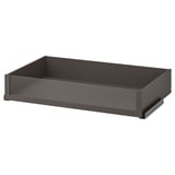 An empty, dark gray KOMPLEMENT drawer with glass front, rectangular shape, and sleek design.