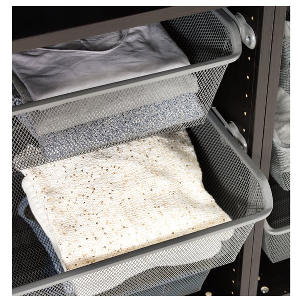 Metal mesh basket stores folded clothes, allows air circulation, prevents small items from falling through.