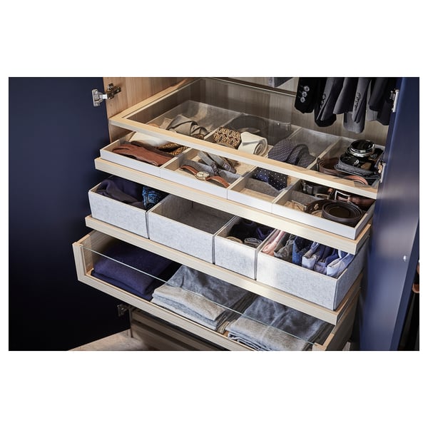 Organized closet with fabric drawers. Accessories neatly folded and stored. Drawers have multiple compartments. Light-colored felt inside drawers.