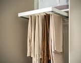 KOMPLEMENT trouser hanger, white, metal, holds beige pants, organized.