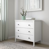 KOPPANG chest with 3 drawers, plant, books, under mirror.