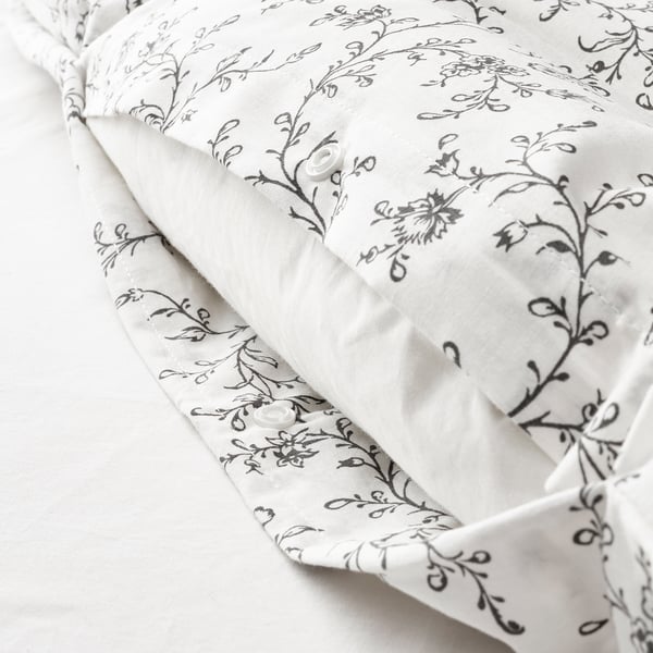 White duvet with floral pattern featuring snap closures, ensuring it stays securely in place.