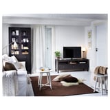 Modern living room with brown KRAGSTA tables, white furniture, tv, and decor.