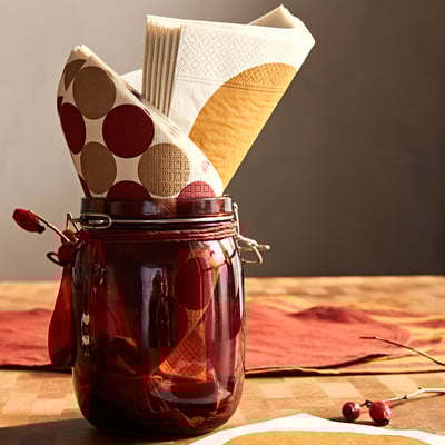 Red glass jar with polka dot napkins, tied with red ribbon.