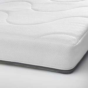 Close-up of baby mattress, seamless design, smooth and wavy sides, zipper pocket detail.