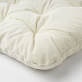 Close-up of luxurious, cream-colored cushion with plush, textured surface. Eco-friendly, recycled materials.