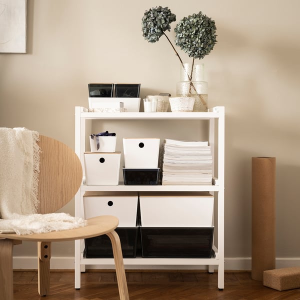 White KUGGIS storage box on shelf, ideal for organizing small items. Stackable, made from pet plastic and bamboo.
