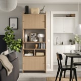 Modern living room with LÅDMAKARE unit and dining area, featuring decor and white kitchen view.