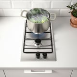 Modern gas stovetop boiling veggies, easy to clean.