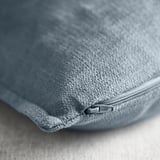 Close-up of a soft, textured, grey cushion cover with a quality zipper.