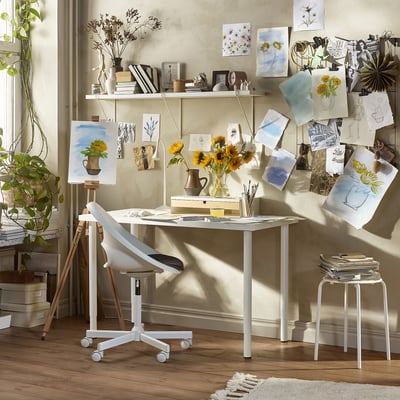 Artists studio with LAGKAPTEN table, chair, and sunflowers.