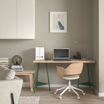 Modern home office with LAGKAPTEN desk, chair, lamp, and books.