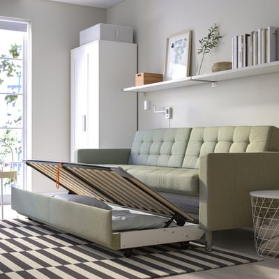 Modern sofa with pull-out bed, storage, and chrome legs. Fabric cover, 10-year guarantee. Sleeps 2, ideal for small spaces.