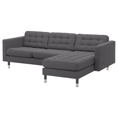 Gray l-shaped sofa with tufted cushions, metal legs, modern design.