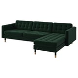Modern dark green l-shaped sofa with plush velvet tufted cushions and wooden legs.