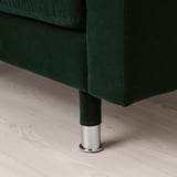Dark green fabric upholstered furniture leg with chrome base; shows craftsmanship and stability.
