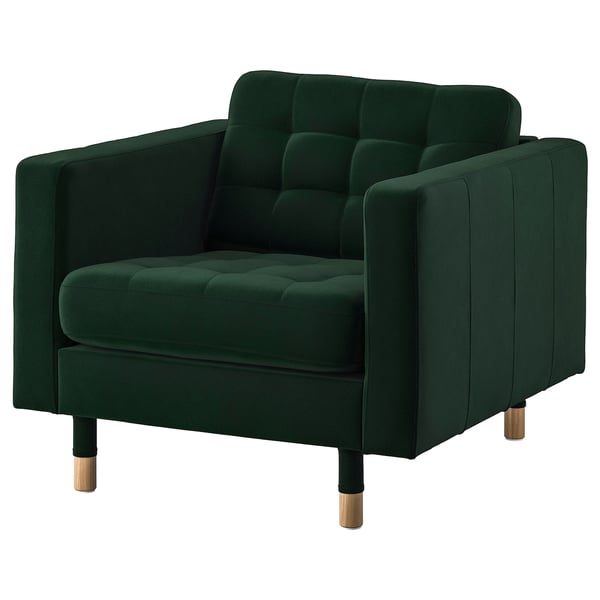 Green tufted armchair with wooden legs.