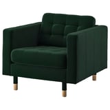 Green tufted armchair with wooden legs.