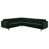 Emerald green l-shaped velvet sofa, eight tufted cushions, wooden legs.