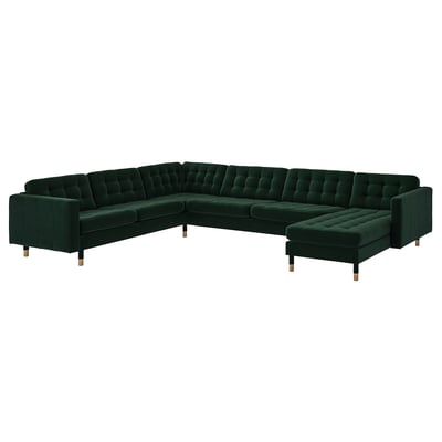 Dark green l-shaped velvet corner sofa with wooden legs & tufted design.