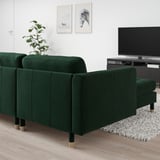 Modern living room with dark green LANDSKRONA sofa, tv, and plant.