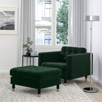 Modern living room with green LANDSKRONA velvet chair and ottoman, smaller than window and lamp.