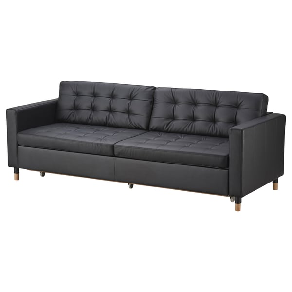 Black leather sofa, LANDSKRONA. Modern design, tufted cushions, wooden legs.