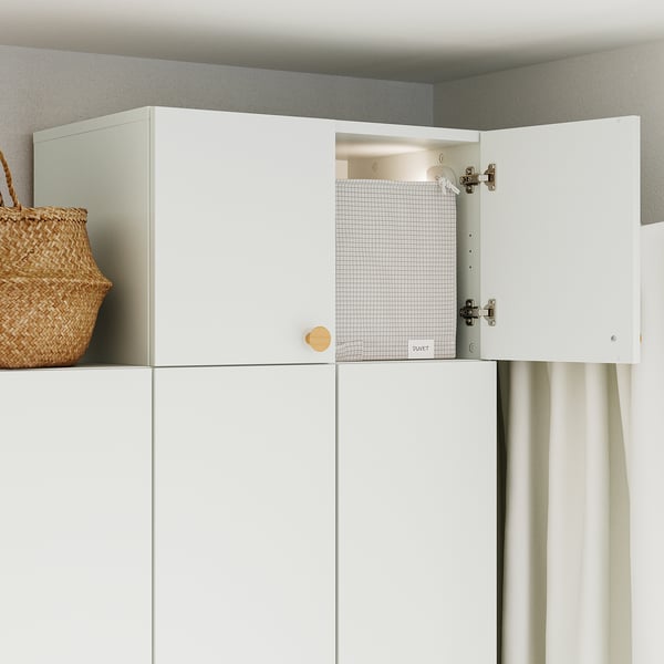 Open kitchen cabinet displaying wire shelf.