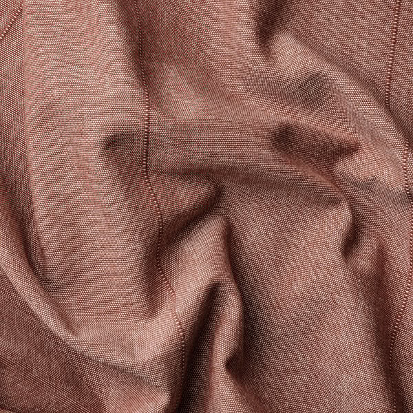 Wrinkled brown-red curtain close-up. Linear weave texture visible, showcasing quality and detail.