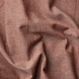 Wrinkled brown-red curtain close-up. Linear weave texture visible, showcasing quality and detail.