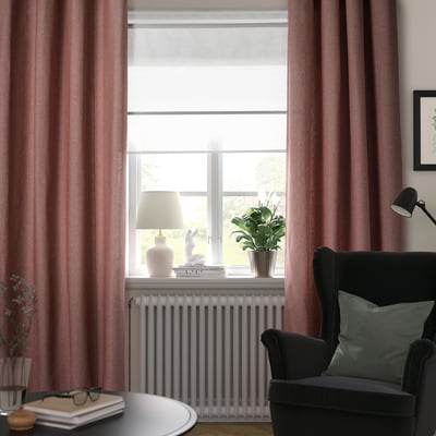 Cozy room with LENDA brown red curtains, a black chair, and a large window. Curtains frame the view, with a radiator beneath.