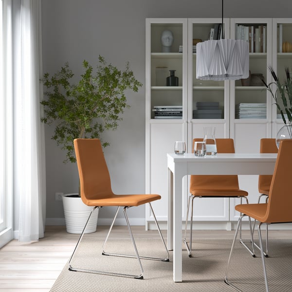 Dining room with LILLÅNÄS chair, cushions, plant, and bookshelf.