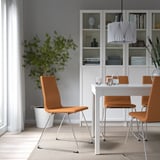 Dining room with LILLÅNÄS chair, cushions, plant, and bookshelf.