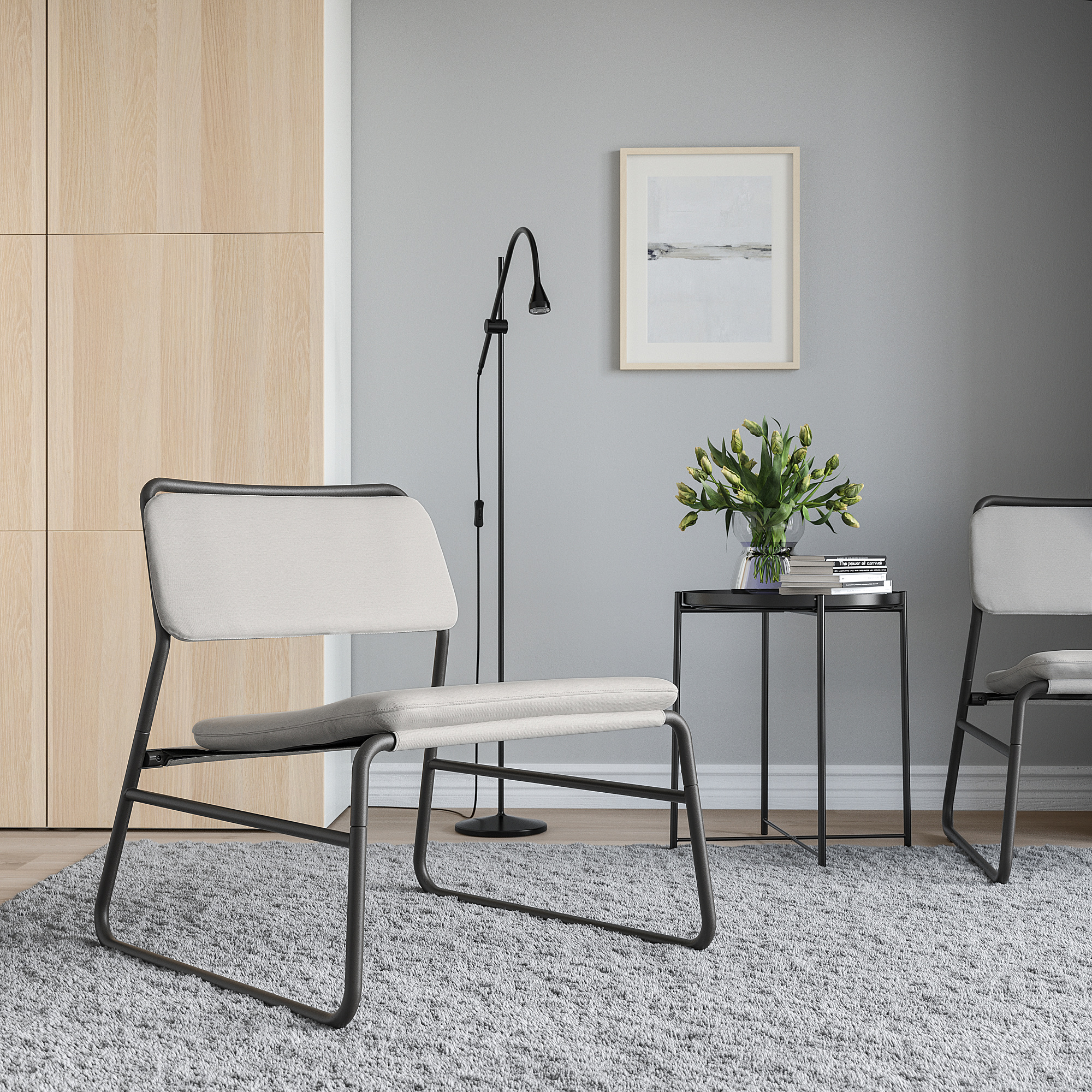 Modern living room with LINNEBÄCK chairs, side table, rug, lamp, and artwork.