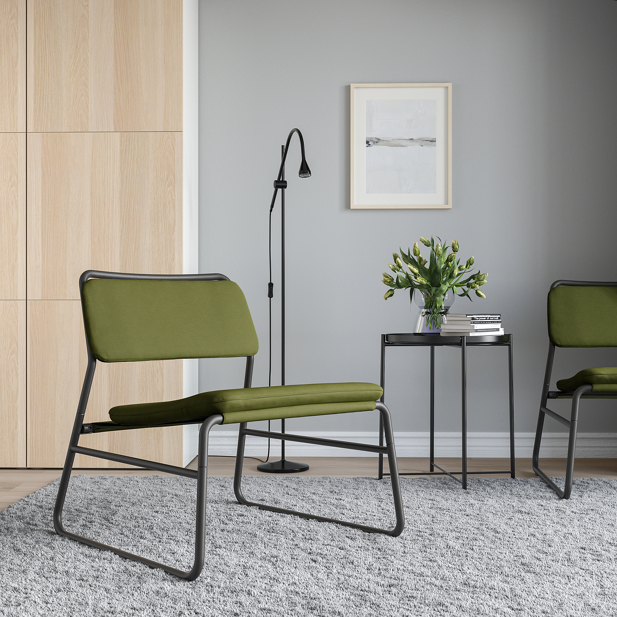 Modern minimalist corner with LINNEBÄCK green chairs, sleek black metal frames, textured gray rug, and simple decor.