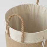 Large woven basket with braided jute handles and removable inner bag.