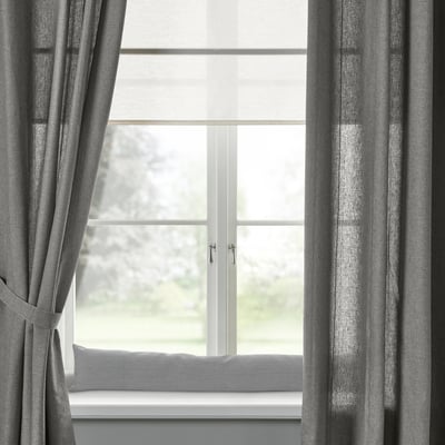 Gray LJUNGSNÄRJA curtains on large window with tree view.
