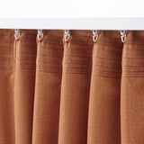 Brown curtains with rings hanging, showing block-out and jacquard design.