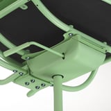 Close-up of green gaming chairs sturdy metal frame and mesh seat, showcasing adjustable parts.