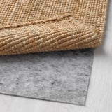 Natural jute rug with non-slip felt backing, perfect for hallways.