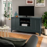 Green LOMMARP tv stand with flat screen, plants & side table. Spacious, classic design.