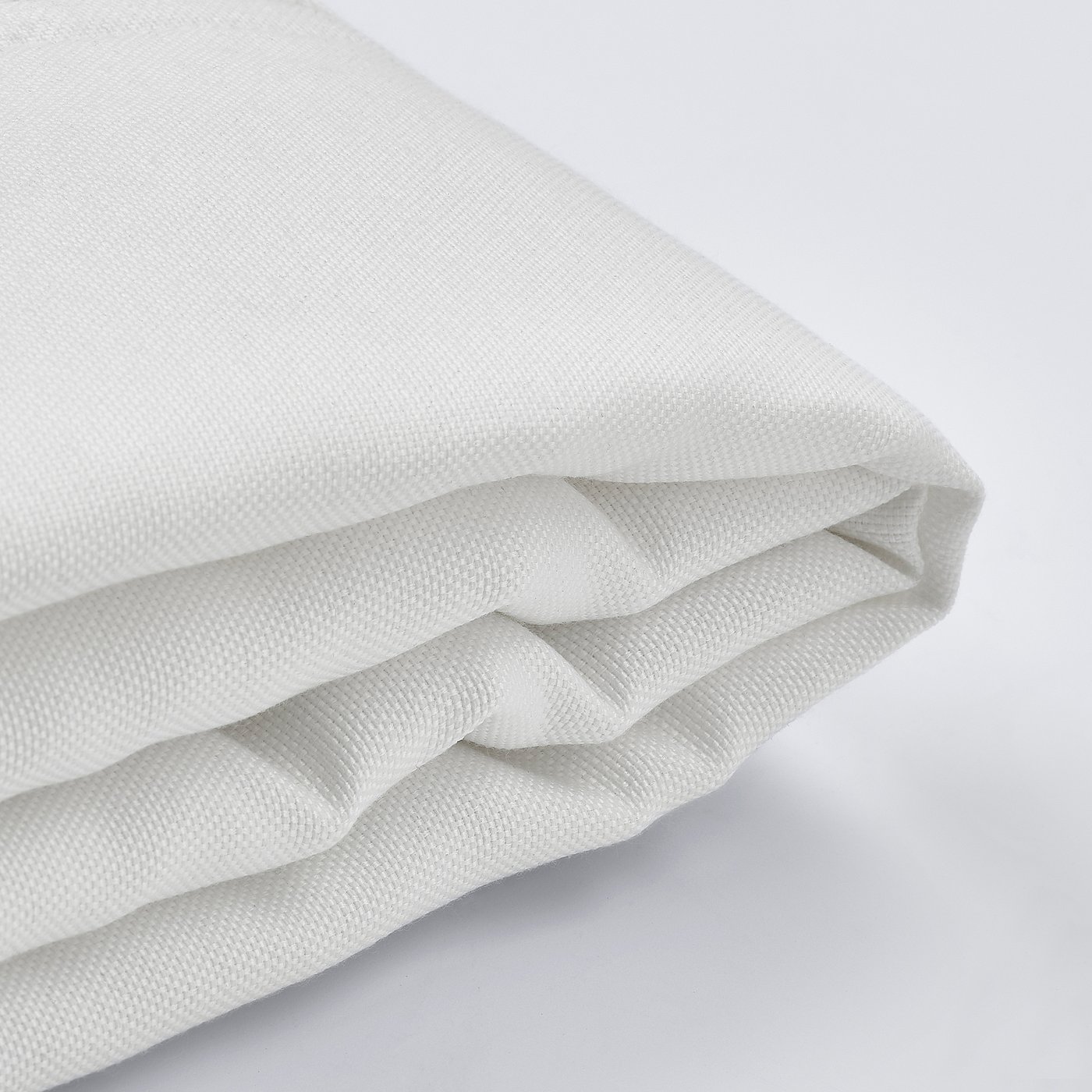 Close-up of white bed cover, soft texture, neatly folded, zip visible.