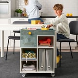 Boy with LYSMASK trolley organizing study materials.