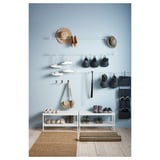 MACKAPÄR hallway organization: shoe racks, hanging baskets, and bags on blue wall.