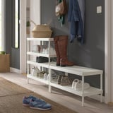 Organized entryway with white MACKAPÄR shoe rack holding boots, sneakers, and a basket with a coat and bag on hooks above.