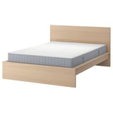 Minimalist wooden bed with light oak finish and grey mattress.
