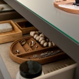 Collection of jewelry neatly arranged in compartments of a stylish, modern box.