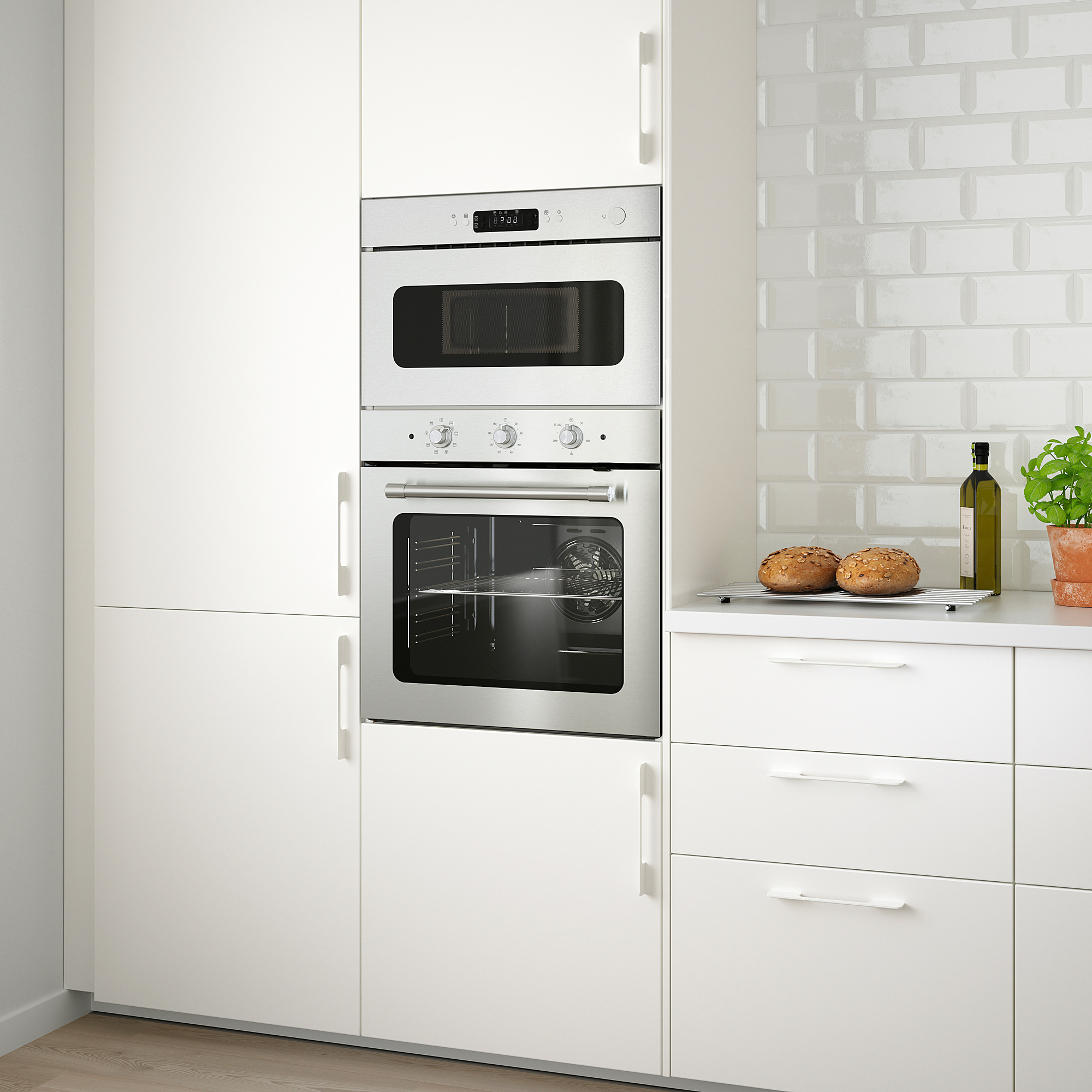 Modern kitchen with MATTRADITION oven and microwave, white cabinets, countertop items.